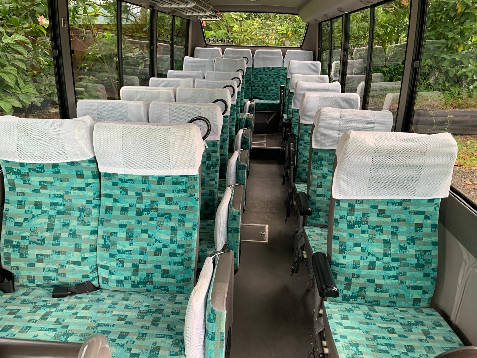 Interior of the Hino bus with green checkered seats