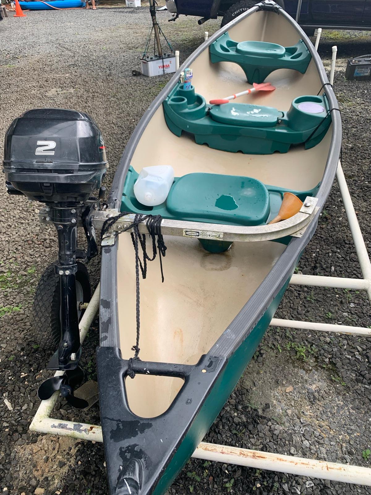 Interior of the canoe showing the seats and outboard motor