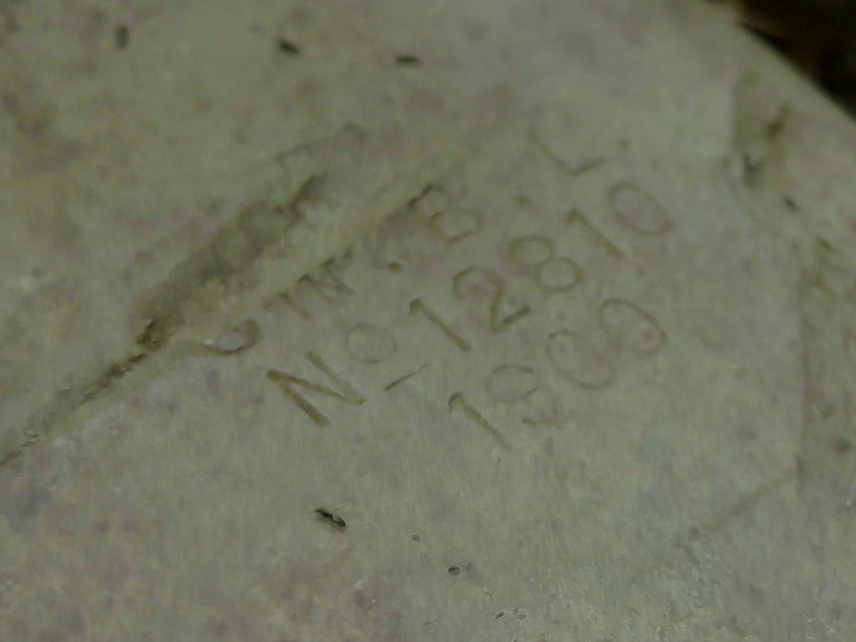 The maker's number and date stamped into a toppled 15 cm coastal gun