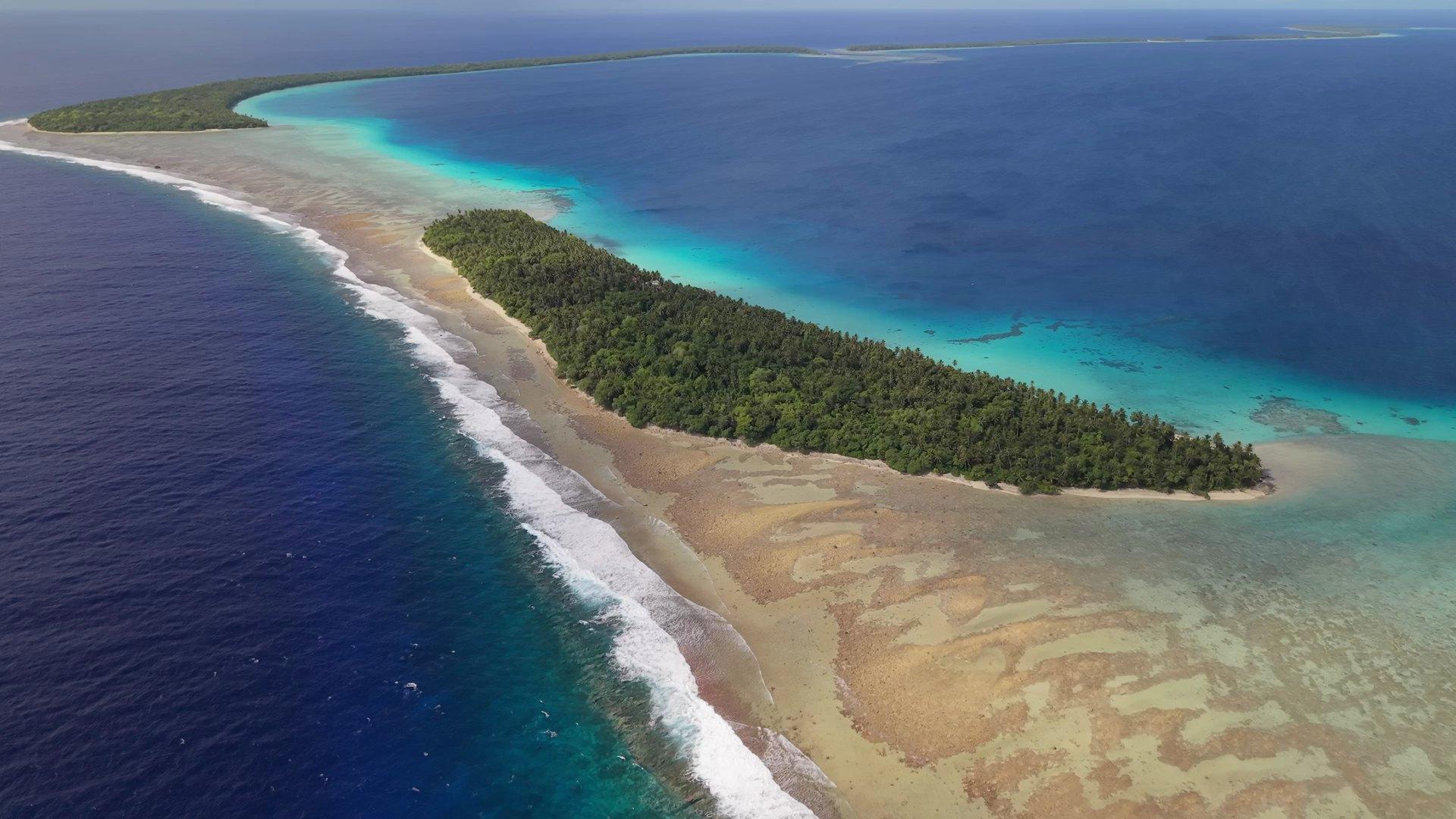 Aerial of Ant Atoll — the reef dividing open-ocean blue from lagoon green