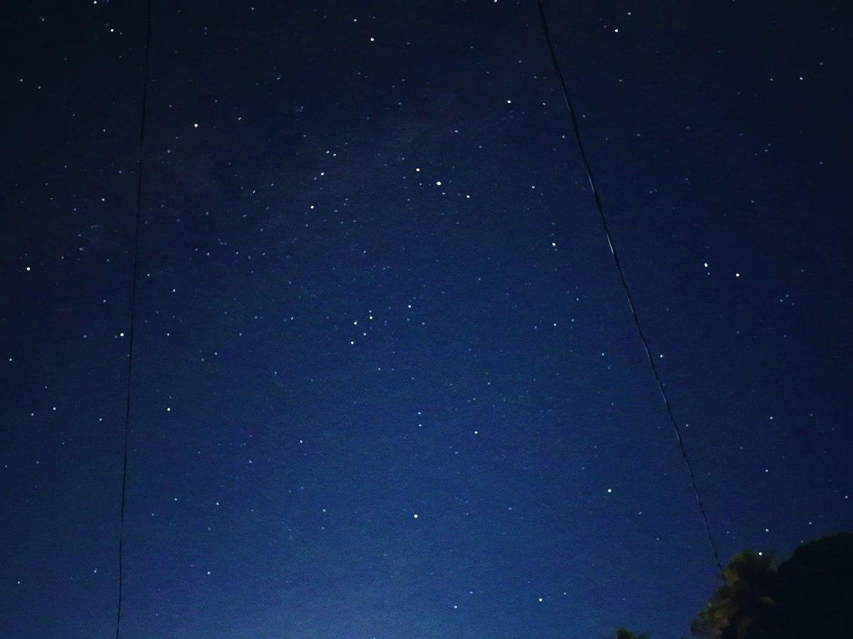 A sky brimming with stars over the dark island night
